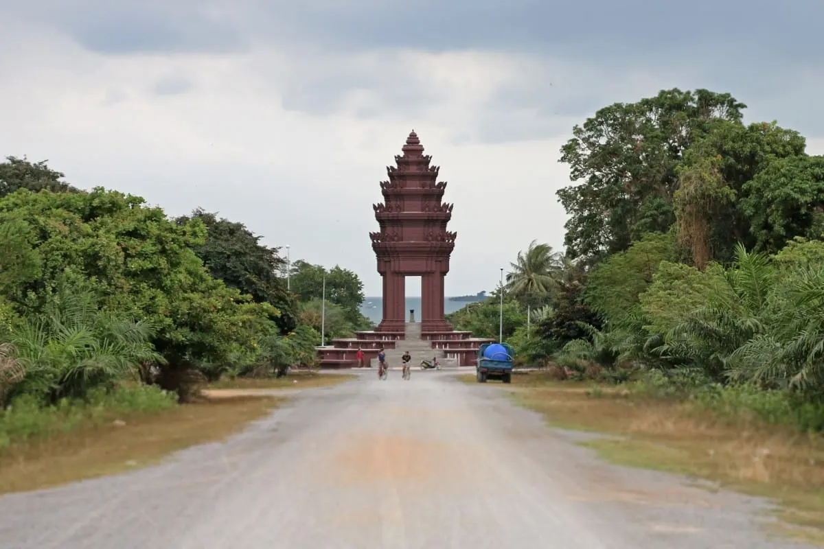 Khmer-style monument at the end of an empty road, with the sea beyond, Kep.