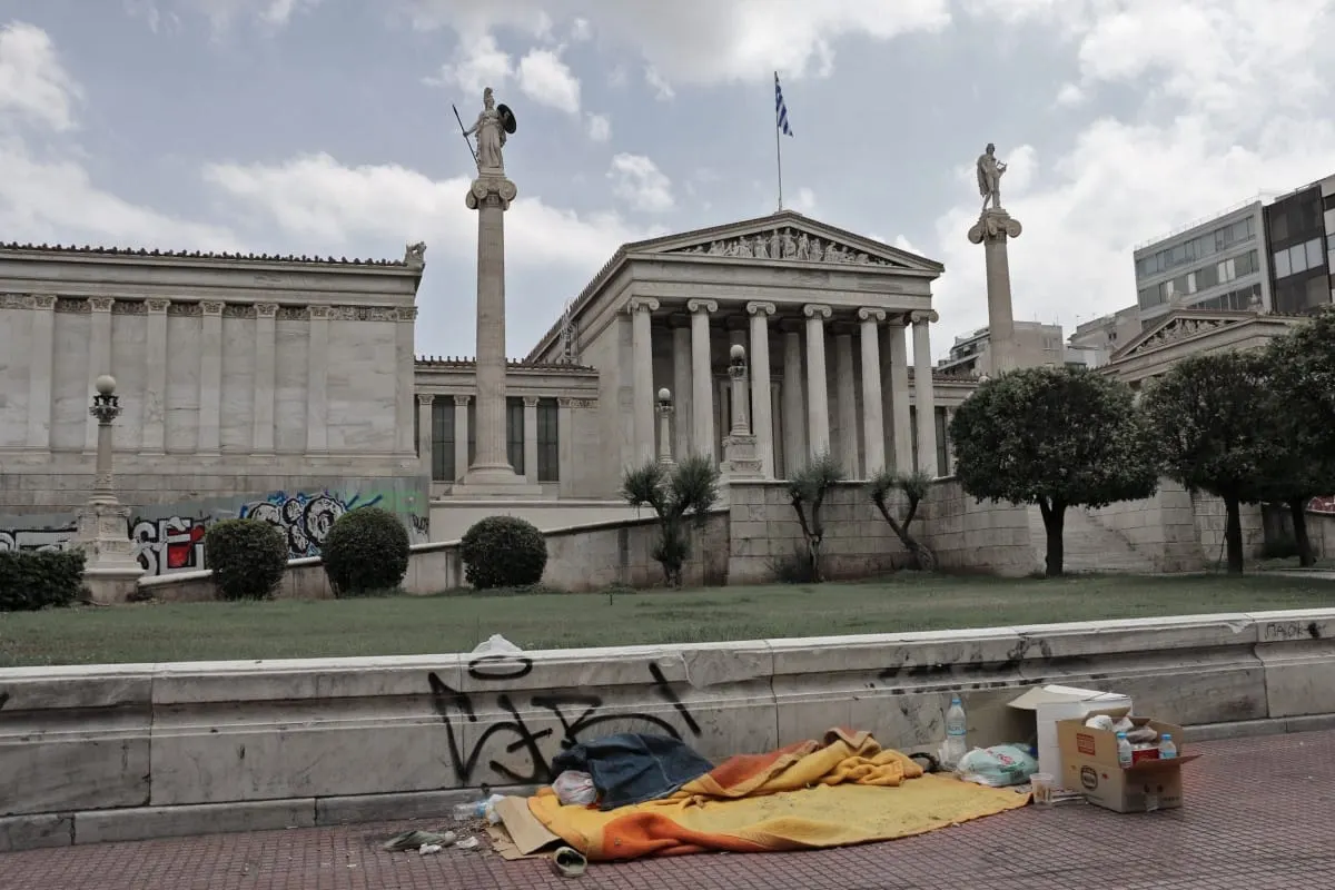Homeless bedding on the pavement before the Academy of Athens