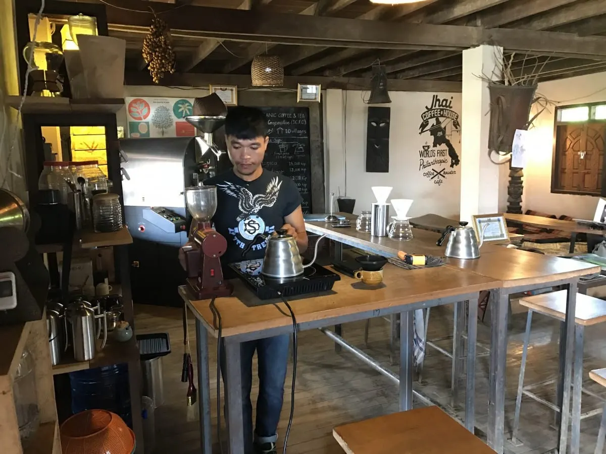 Barista brewing coffee at Jhai Coffee House in Paksong, Bolaven Plateau