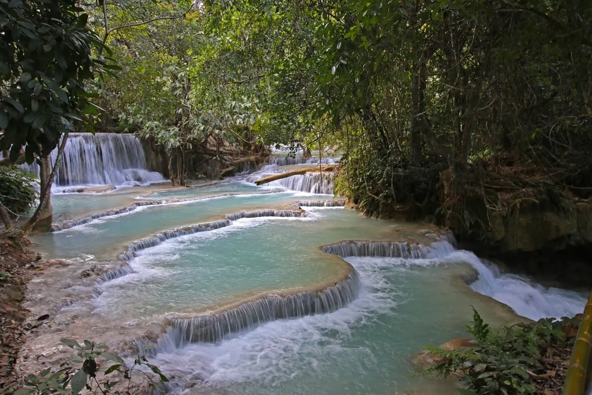 Tiered turquoise pools and small cascades at Kuang Si Falls