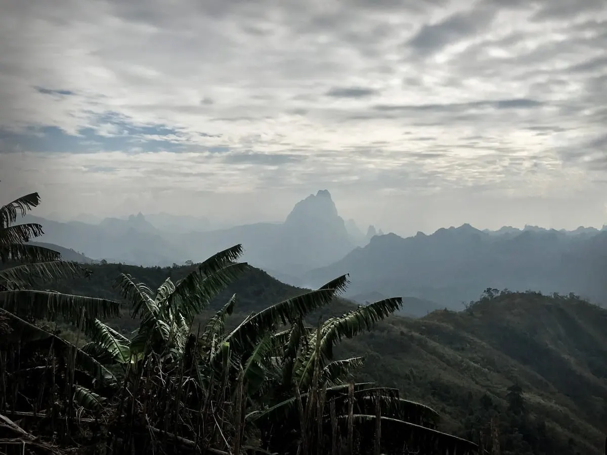Hazy karst peaks beyond banana trees in the mountains of Laos