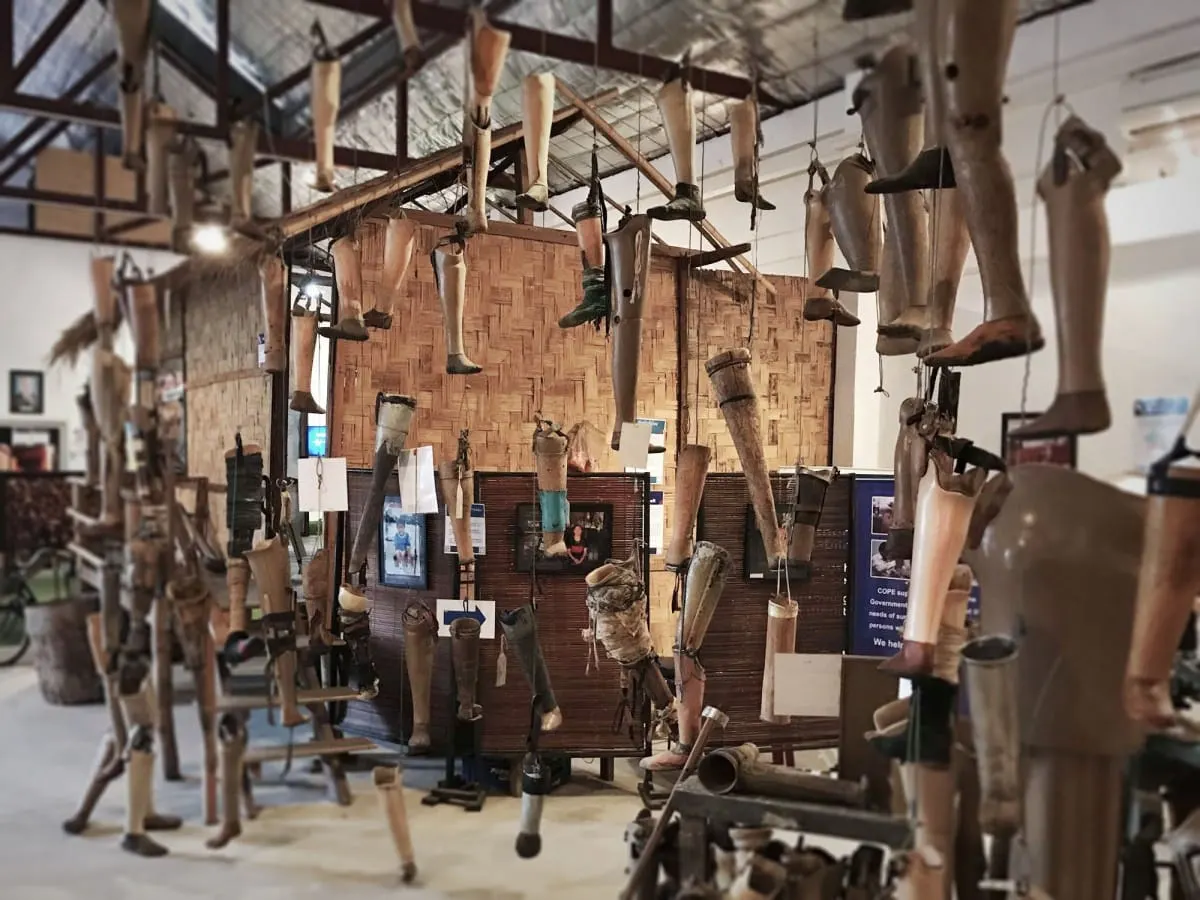 Old prosthetic legs hanging from the ceiling at COPE, Vientiane