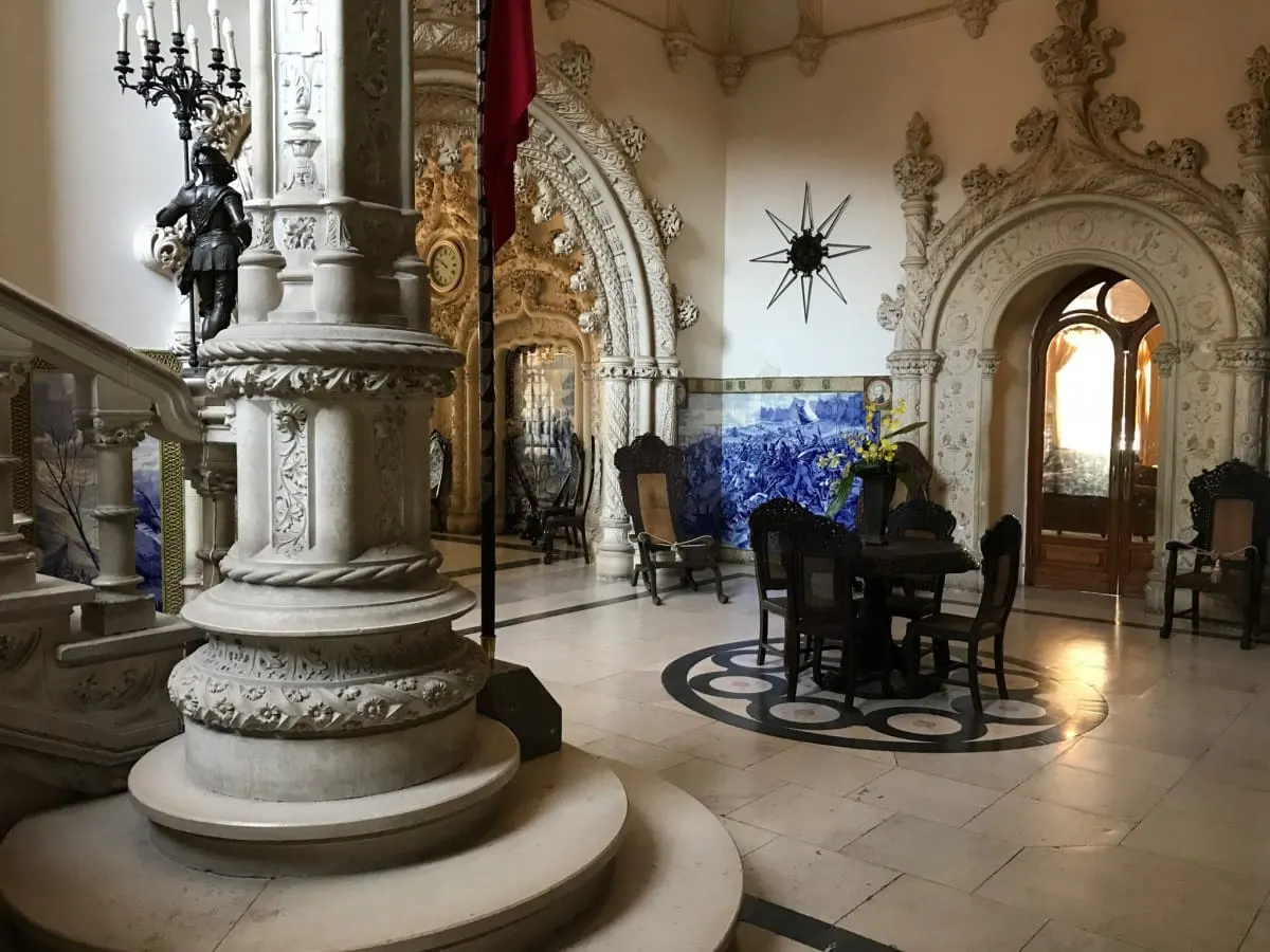 Carved stone hall of Bussaco Palace with suit of armor and blue azulejo panels