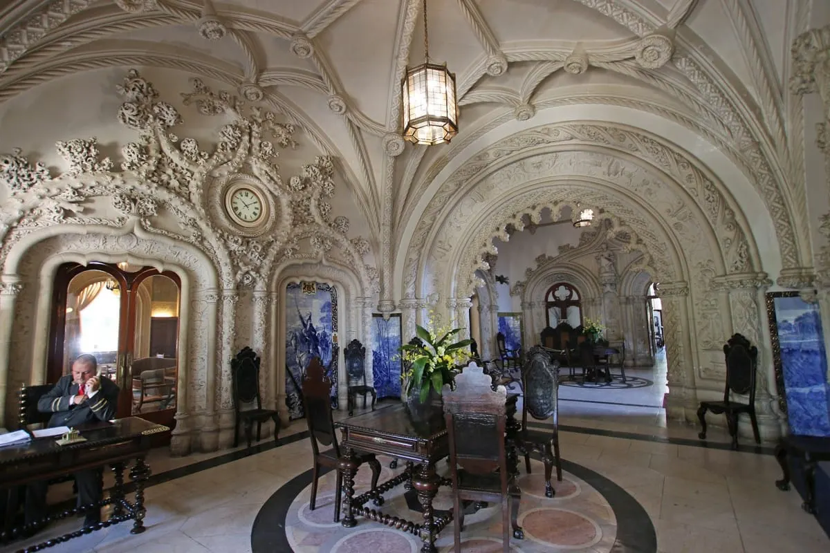 Ornate vaulted lobby of the Palace Hotel do Bucaco with carved stone and lantern