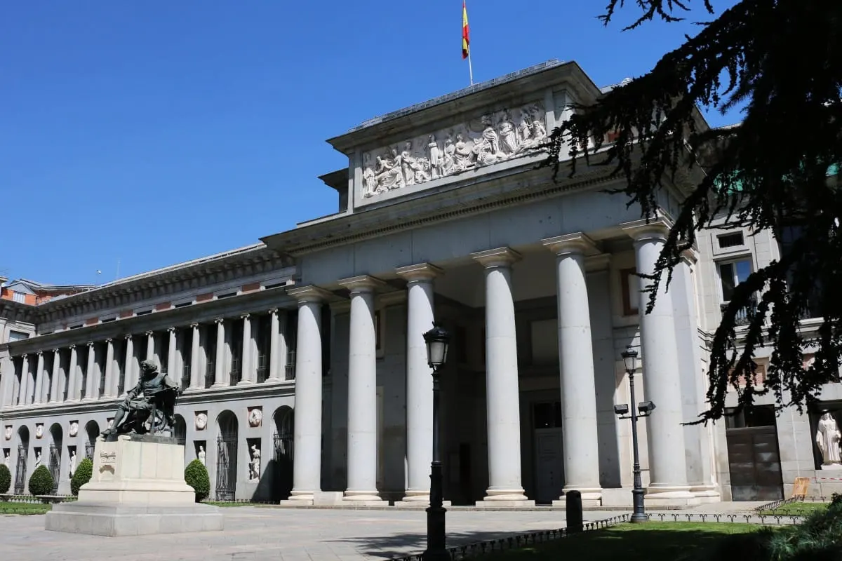 Columned Velazquez entrance of the Prado Museum with statue, Madrid