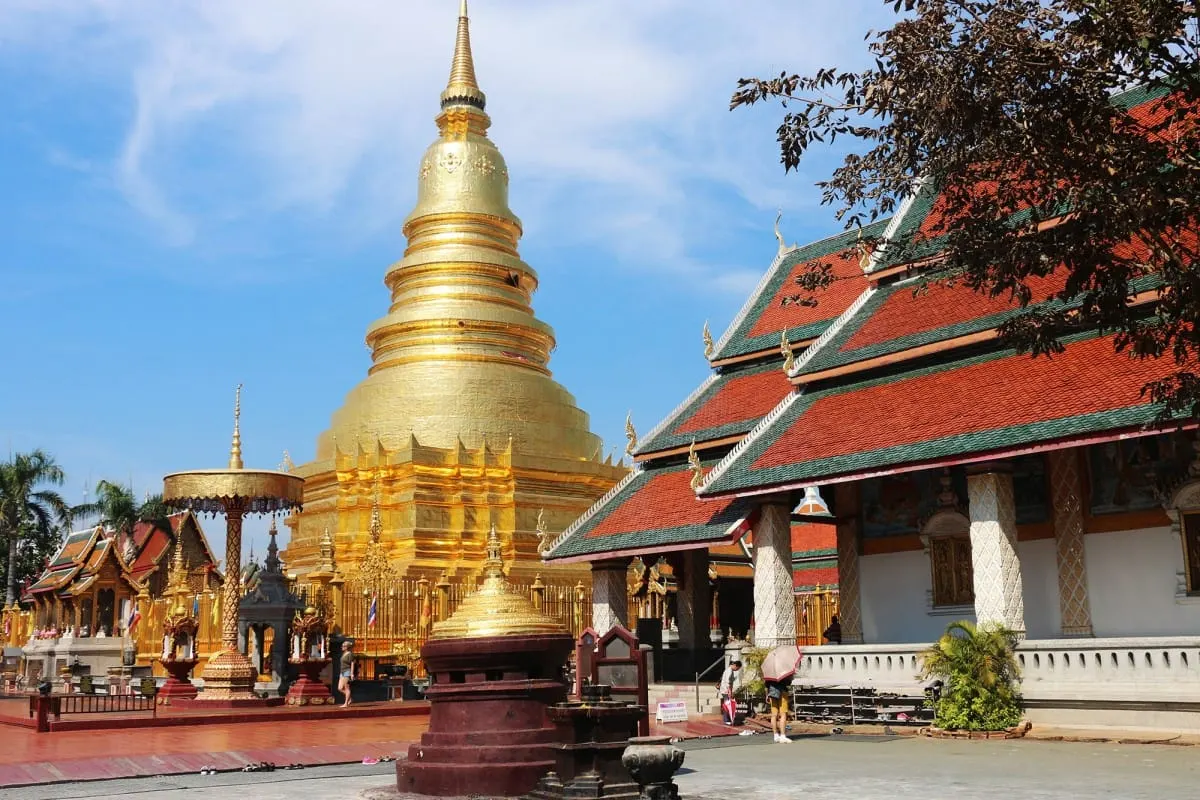 Golden chedi and red-roofed temple hall at Wat Phra That Hariphunchai, Lamphun.