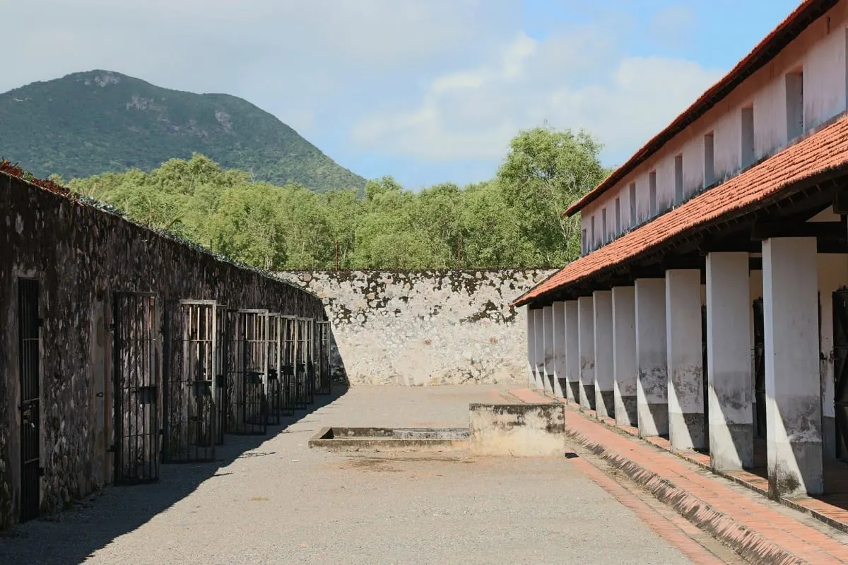 Prison courtyard between barred open-air cells and the tiger cage building, Con Dao